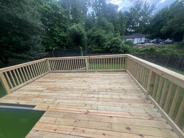 Custom pressure-treated deck with full railing built by Pittman Construction
